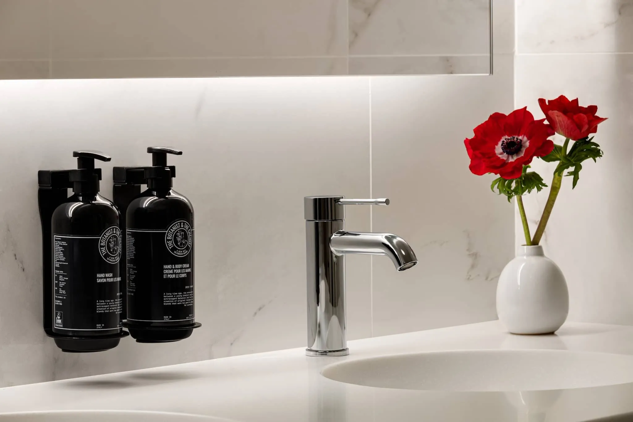 The private bathroom in the King Deluxe Mobility / Hearing Accessible with Tub features an accessible tub with handrails, along with a sink and toilet