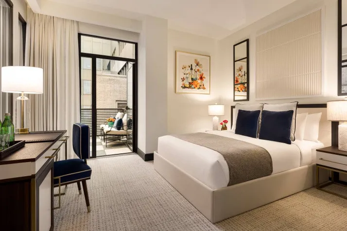 Our elegant New York City hotel rooms feature white bedding and natural lighting
