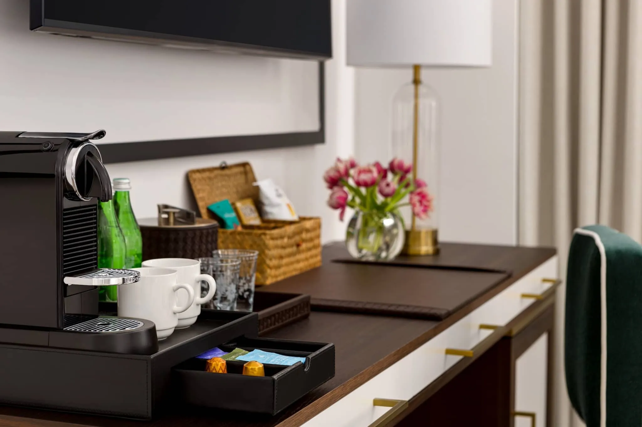 The King Deluxe Mobility / Hearing Accessible with Roll-In Shower's workstation features a coffee machine and drink accessories to start your day with