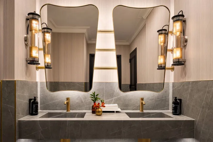 The bathroom in the Penthouse at The Chemists' Club Hotel combines pendant lighting with contemporary elegance in Midtown Manhattan